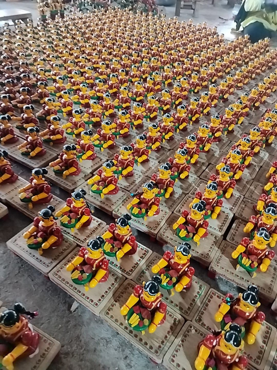 Artisan at work — wood carving and hand painting